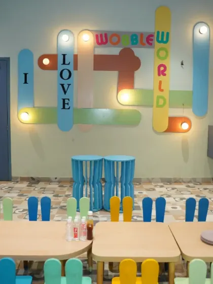 The dedicated kids' dining area, complete with fun, colorful chairs and our "I Love Wobble World" wall art.