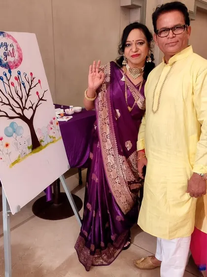The grandparents-to-be happily posing by the gender reveal voting tree. These interactive elements create wonderful photo opportunities and lasting memories for the whole family.