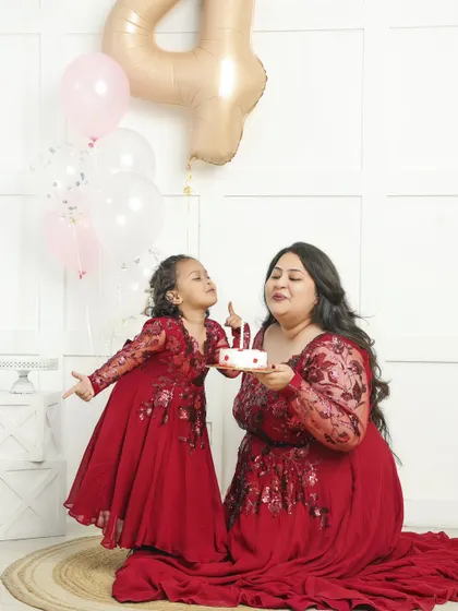 The bond between a mother and child is precious. This birthday photoshoot captures a tender moment of celebration, with matching outfits that highlight their special connection.