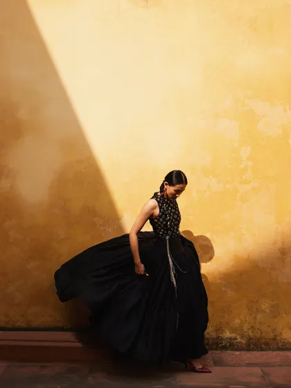Another shot playing with the movement of the black dress against the yellow wall.