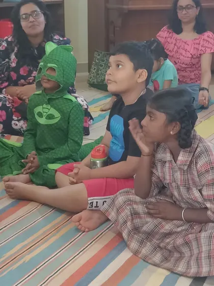 A close up on the audience, showing their focused and engaged expressions during the monster story.