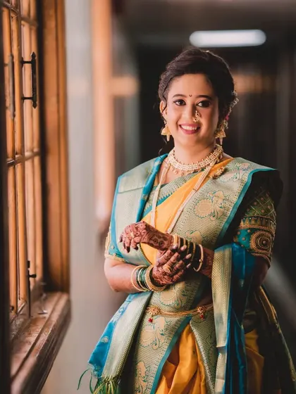 A happy and confident bride, ready for her big day. Her makeup is fresh and radiant, and her smile is the perfect finishing touch.