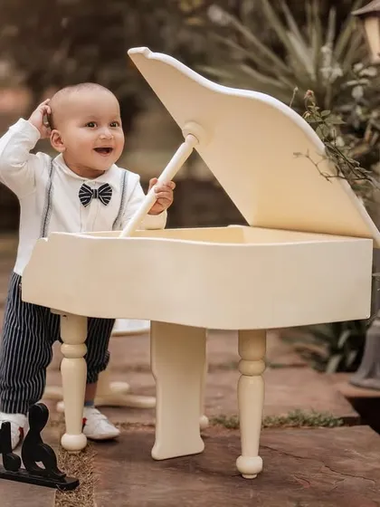 A curious little musician exploring the piano. I love capturing these moments of discovery and play during my themed photoshoots.