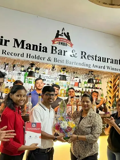 A student being felicitated with a certificate and bouquet after a competition or course completion.