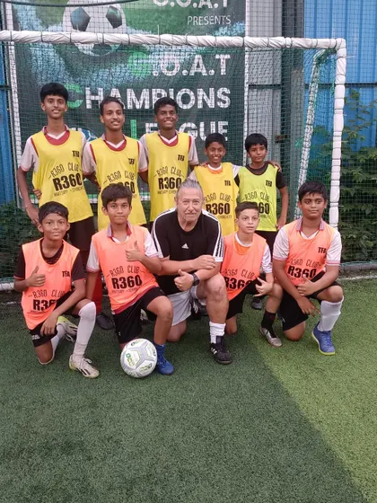 Khush Modi with his coach and teammates, a snapshot of the supportive environment that helped him succeed.