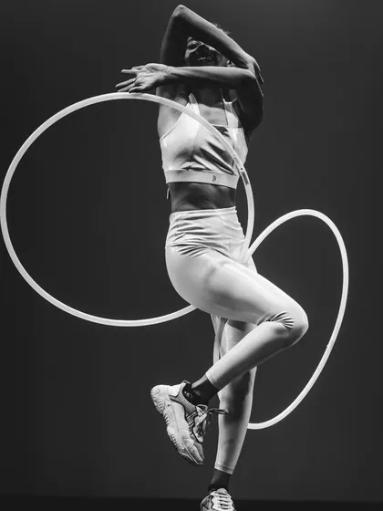 A black and white shot showing the shapes I can create with my body and two hoops. Hoop dance is like drawing circles in the air, a constant exploration of geometry and movement.