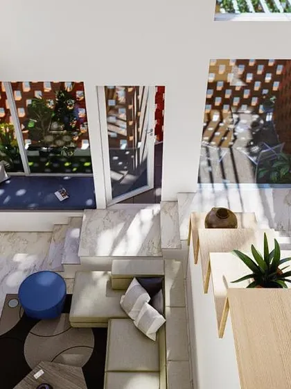 An aerial view of a double-height living space designed to feel expansive and intimate at the same time. This open-well atrium design is one of my key strategies for flooding homes with natural light and creating visual connections between floors.