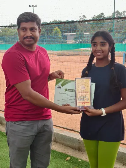 Presenting the runner-up trophy to Hamsini for her performance in the Girls Under 14 category. Her strong showing in the tournament is a credit to her training.