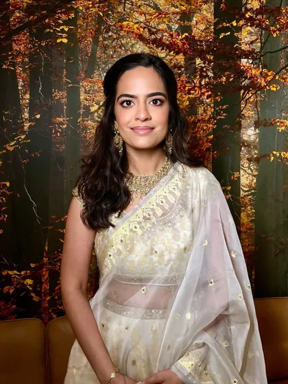 This bridesmaid is the picture of elegance. Her soft makeup and wavy hair are perfect for a wedding celebration.