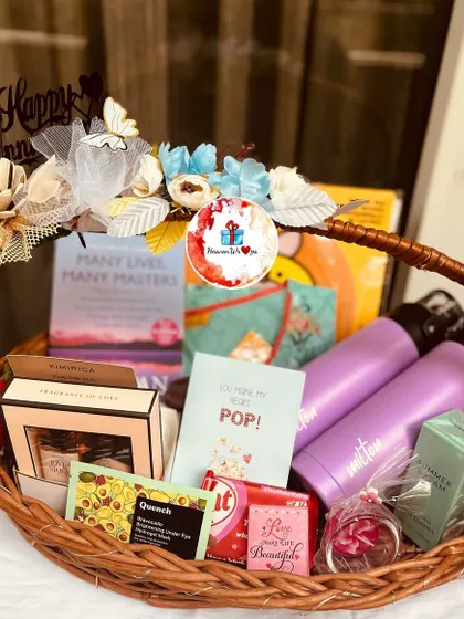 Another angle of the anniversary basket, showing the arrangement of the book, water bottles, and other gifts.