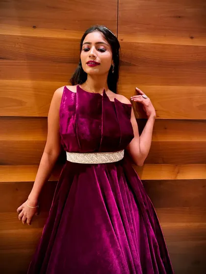 A close-up shot showing the beautiful neckline and rich color of the magenta velvet gown.