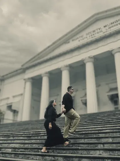 A classic pre-wedding pose on the steps of The Asiatic Society of Mumbai Library. The colonial architecture provides a grand and timeless setting for elegant couple portraits.