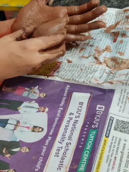 A child's hands covered in clay, fully engaged in the tactile experience. This image captures the essence of sensory play, which is so beneficial for a child's development and emotional well being.