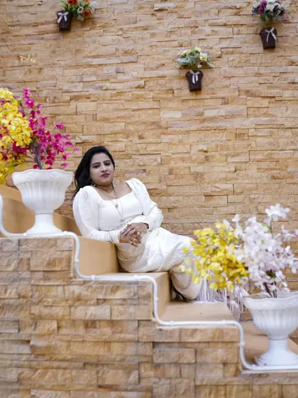 A relaxed and elegant pose on a decorative staircase during a special occasion photoshoot.