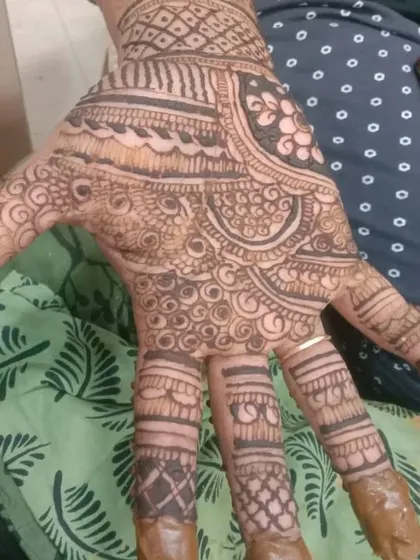 This intricate design covers the entire palm with fine, swirling patterns. It's a testament to patience and precision, perfect for someone who loves extremely detailed henna work.