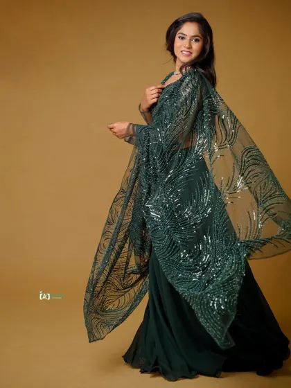 This shot captures the beautiful drape of the sequined dupatta. The movement adds a touch of magic and elegance to the portrait.