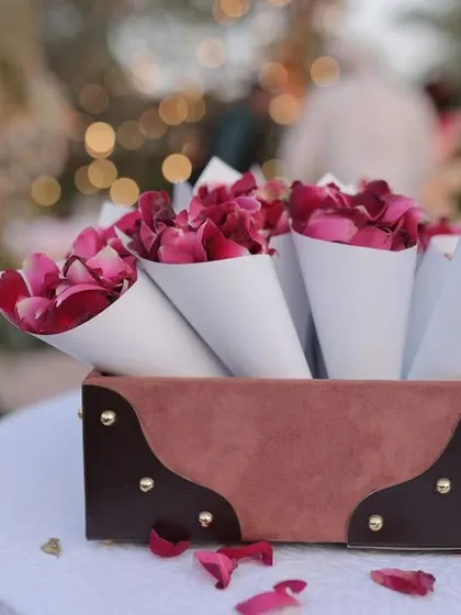 The smallest details often make the biggest impact. For this event, I prepared these elegant paper cones filled with fresh rose petals, allowing guests to shower the couple with blessings in a beautiful and photogenic way.