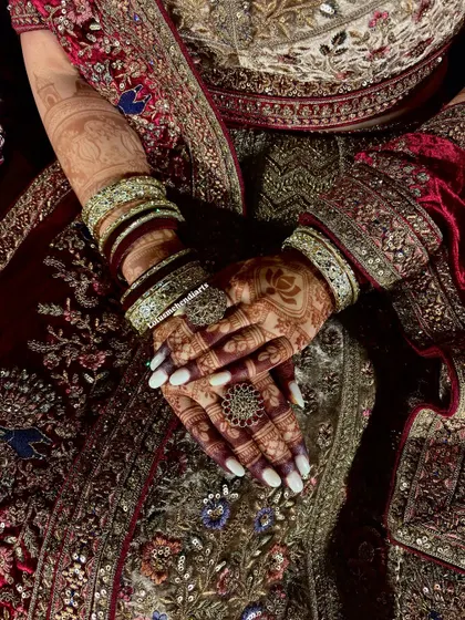 Another view of the fresh stain, showing the beautiful contrast with the bride's white nail polish and intricate outfit.