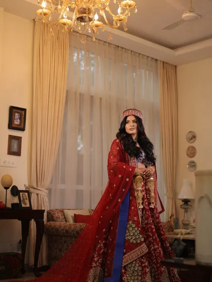 A beautiful shot showcasing the bride's full traditional attire. The makeup was kept classic and elegant to complement the rich colors and sentimental details of her outfit.