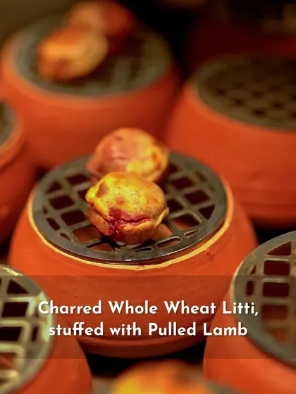 Charred Whole Wheat Litti stuffed with Pulled Lamb, representing the rustic flavors of Bihar in a modern format for the 'Sounds of India' menu.