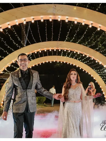 Walking hand-in-hand through an illuminated archway, the couple's Sangeet entrance was pure magic.