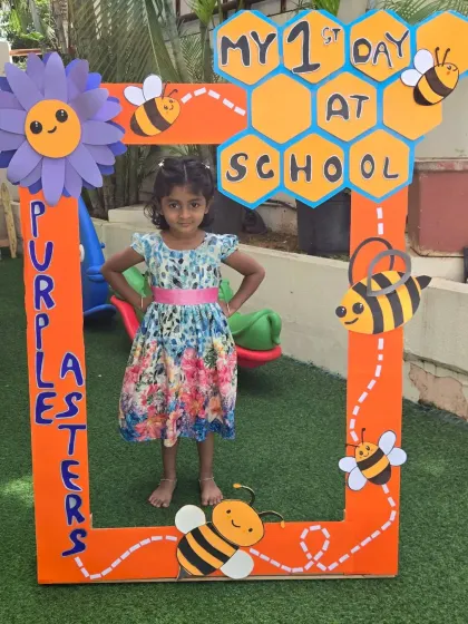 This little girl is striking a pose on her first day at Purple Asters. We can't wait to see her blossom.