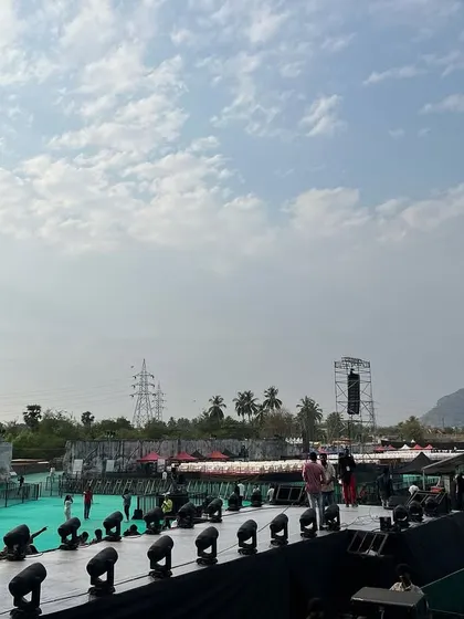 The view from the side of the stage at the Harris Jayraj concert. The depth of the stage and the extensive lighting setup along the front truss are visible, all supported by our infrastructure.