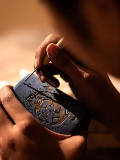 A focused shot of a student carefully carving intricate patterns into a mug during our sgraffito workshop. It's a technique that requires patience but yields beautiful results.