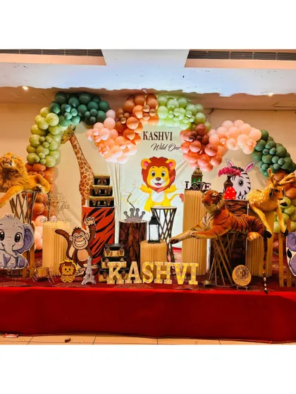We can customize our jungle theme to fit your vision. This setup for Kashvi's "Wild One" party includes a mix of cartoon and plush animals, creating a playful and inviting atmosphere on stage.