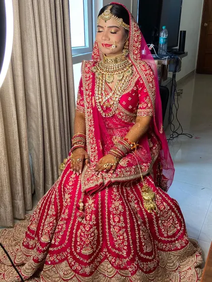 A complete view of the bride's stunning red lehenga and the glamorous makeup designed to complement it.