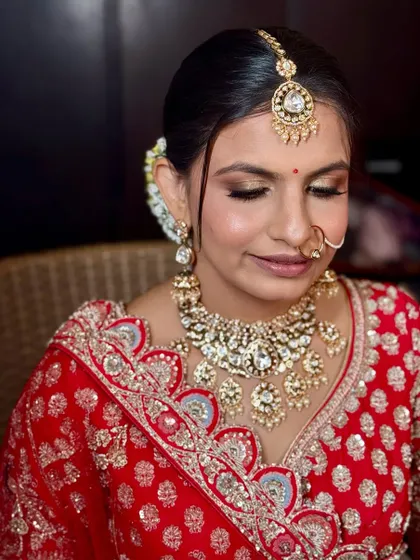 A close-up showing the soft gold and brown eyeshadow, which complements the heavy Kundan jewelry perfectly.