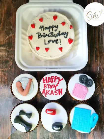 Another fun take on a fitness theme, this set includes a bento cake with a simple birthday message and cupcakes topped with fondant dumbbells, towels, and a sculpted bicep.