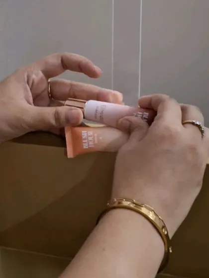 A close-up of hands carefully arranging the Mars "Blush Hour" tubes for a product shot.