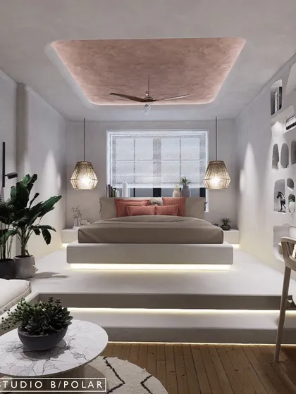 In another Wabi-Sabi inspired bedroom, we raised the bed on a two-step platform with integrated lighting, creating a distinct and elevated sleeping nook. The ceiling features a pink textured paint, adding a soft pop of color.