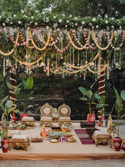 A mandap decorated for a cross-cultural wedding, blending South Indian floral elements with a unique structural design.