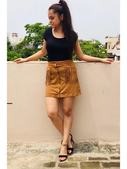 A simple black top paired with a statement suede skirt with fringe details makes for a stylish weekend look. It's all about balancing basic pieces with more unique items to create interest.