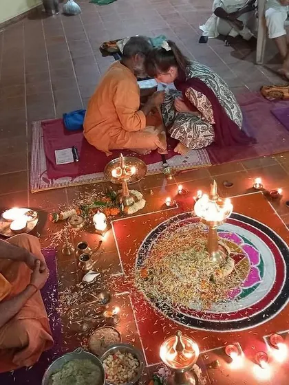 A student receives blessings during a traditional puja ceremony for our Yoga Teacher Training Course. These sacred rituals are an integral part of our curriculum, connecting us to the ancient lineage of yoga.