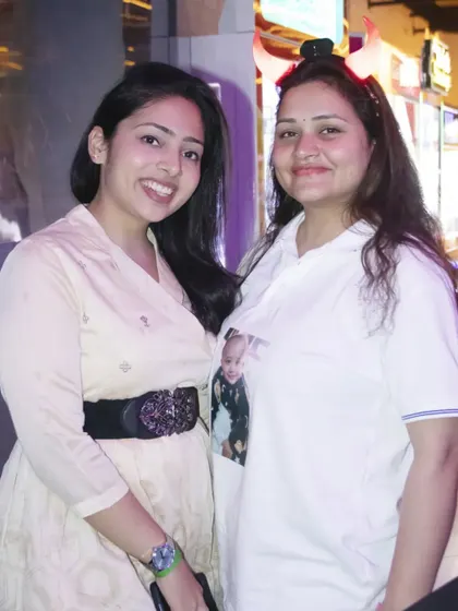 Two friends smiling for a photo at a party. I document the friendships and connections at your celebration.