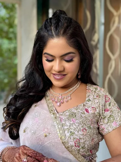 Reception glam magic. This look features a beautiful pop of purple on the eyes, paired with glowing skin and a soft lip.