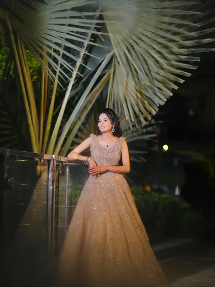 A full view of the sparkling engagement gown. The makeup is kept elegant to balance the heavily embellished dress.