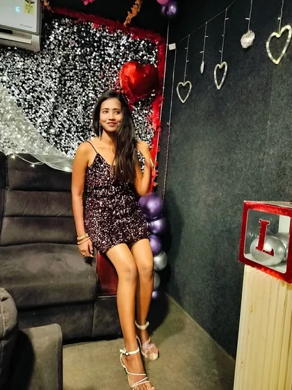 A guest enjoying her quiet moment during her 25th birthday party, surrounded by romantic decorations.