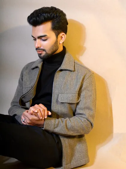 This seated portrait conveys a sense of quiet contemplation and style. The composition and pose are carefully directed to create a sophisticated and approachable look, perfect for lifestyle branding or an actor's portfolio.