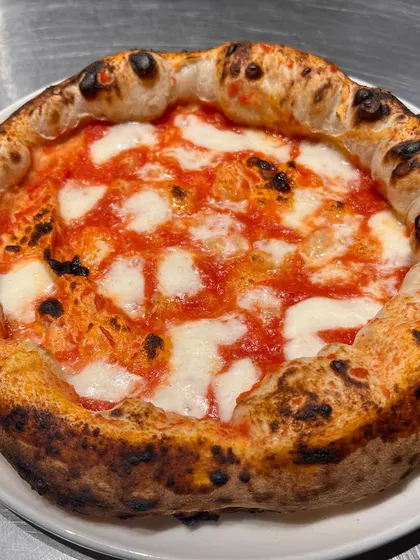 A perfect Margherita in the making. This is a trial run where we're always chasing that perfect, puffy crust.