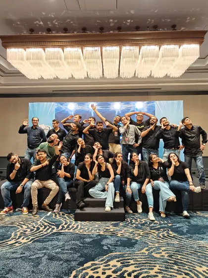 A fun, candid moment with the whole crew after a successful event. This picture perfectly captures the playful and supportive spirit of our AnD family.