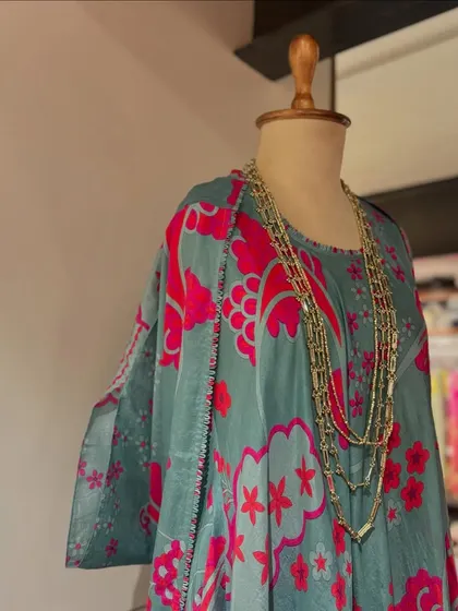 Embracing summer with florals. This printed kaftan in teal and pink is paired with a layered gold necklace for a relaxed, bohemian vibe.