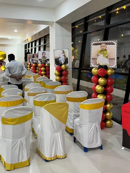 The guest seating area for the racing-themed party, with chairs decorated to match and photo displays on balloon columns.