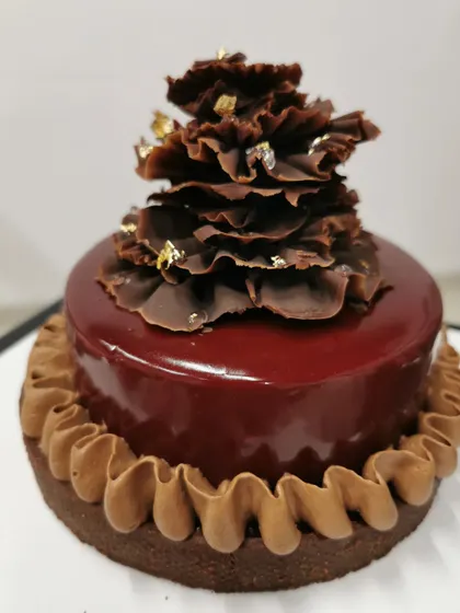 This is my raspberry chocolate tart. It has a rich, buttery chocolate crust, a smooth chocolate filling, and a glossy raspberry glaze, all topped with delicate chocolate ruffles and a touch of gold leaf. It’s a dessert for true chocolate lovers.