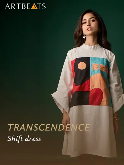A studio shot of the Transcendence shift dress. The clean lines and bell sleeves create a modern silhouette, while the abstract artwork serves as a powerful focal point.