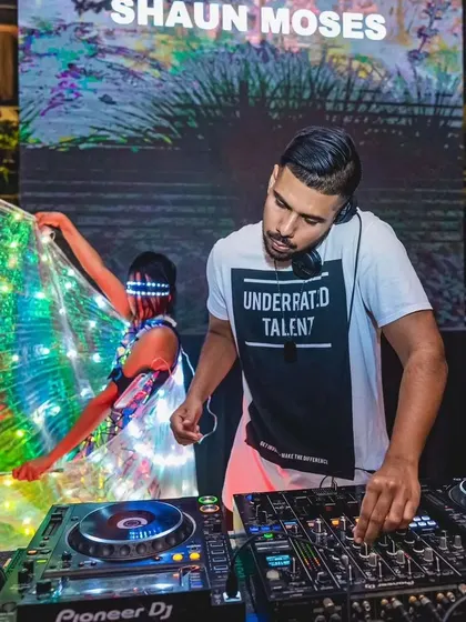 Performing with LED wings behind the DJ at an Ambrosia Social event. The lights from the wings pulse and change with the music, creating a synesthetic experience.