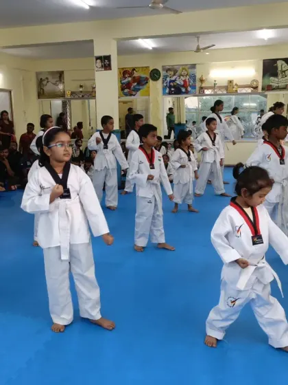 A class of white belts practicing their low block.